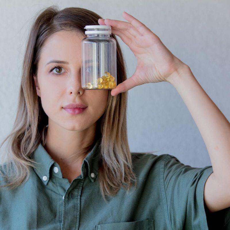 woman-keeps-transparent-jar-with-pills-at-eye-level-1.jpg