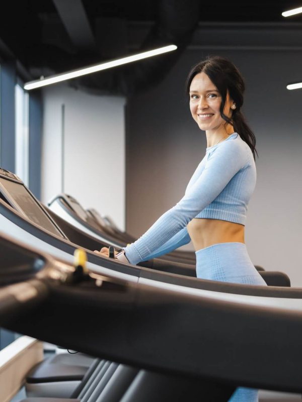 cheerful-fitness-girl-walking-on-a-treadmill-1.jpg